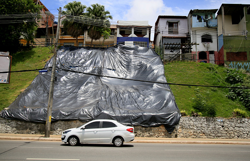 salvador, bahia, brazil - january 29, 2021: black canvas is seen on a hillside where there was delimitation of land near the Dique do Tororo, in the city of Salvador.