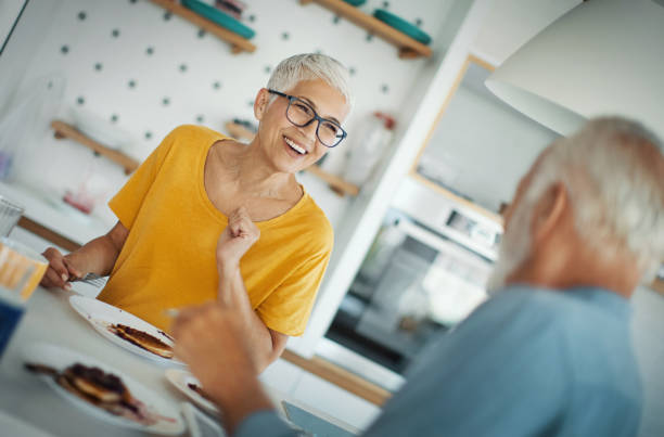 istock Mature couple having breakfast at a kitchen counter. 1308704560