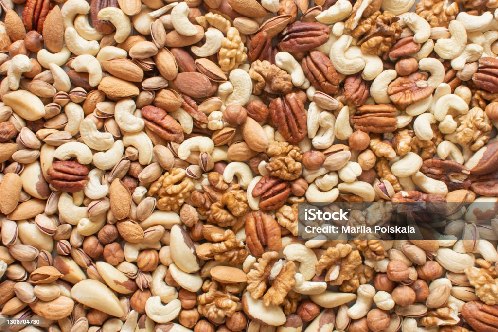 Assorted nuts: hazelnuts, walnuts, brazilian nuts, pecans, pistachio, almonds, cashews Flatlay organic mixed nuts background. Healthy food, useful microelements and vitamins. Useful health snack. Assorted nuts: hazelnuts walnuts, brazilian nuts, pecans, pistachio, almonds, cashews. Flatlay organic mixed nuts banner. Healthy food, useful microelements and vitamins. Useful health snack Nut - Food Stock Photo