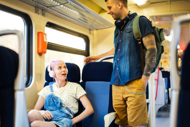 istock Two young people talking on the train 1308705515