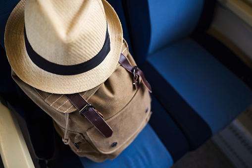 High angle view of a backpack and a hat on the passenger seat.