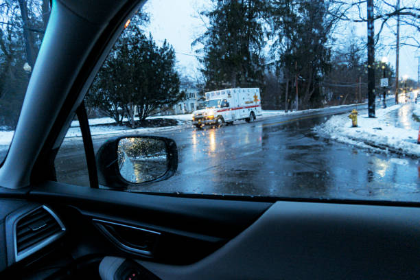 istock Rain Storm Blurred Ambulance Speeding Through Road Intersection 1308705977