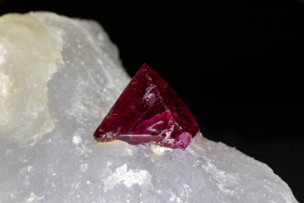istock Red spinel crystal, uncut, in white host rock. Black background. 1308706867