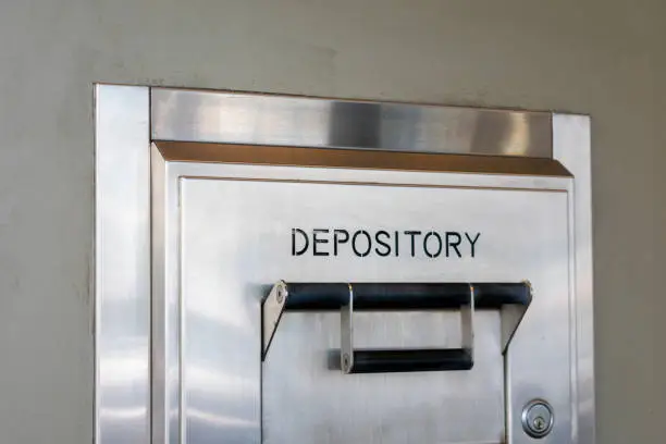 Photo of Depository sign on an exterior secured bank drop box