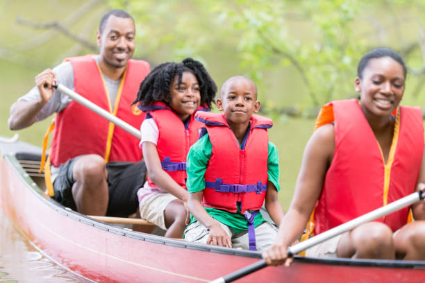 istock African Family Wearing Life Jackets While Canoeing 1308717450
