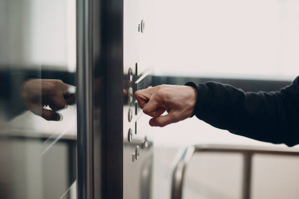 istock Close up of forefinger pressing the button elevator during coronavirus pandemic covid-19 quarantine concept 1308718876