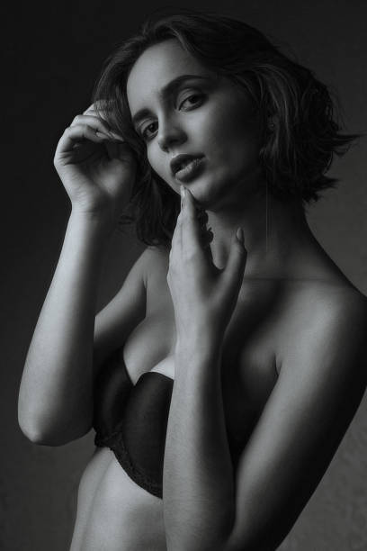 istock Wonderful model wears lingerie posing in the dark studio 1308719324