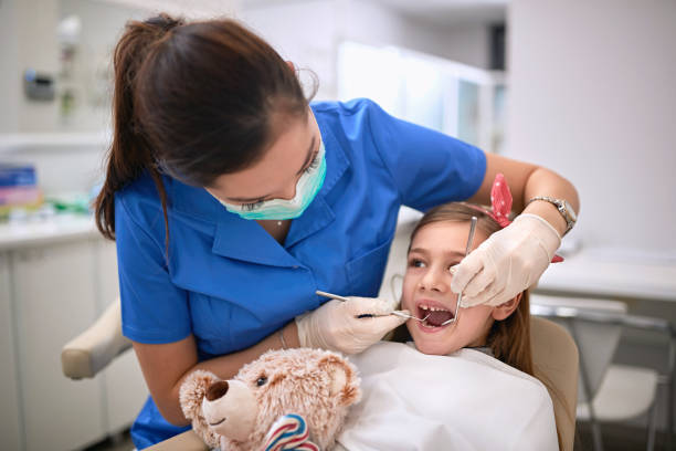 istock Dentist working with little patient 1308720473