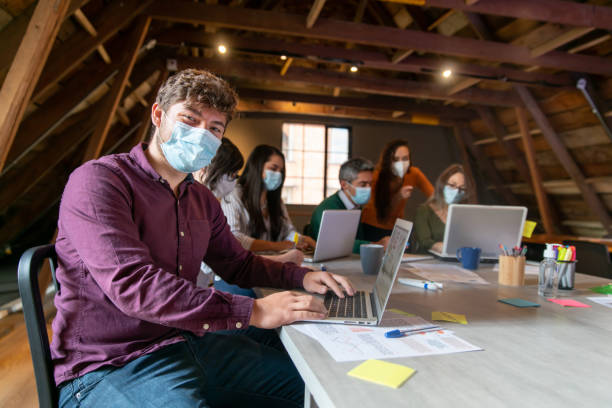 istock Entrepreneur wearing a facemask while working at a creative office 1308721116