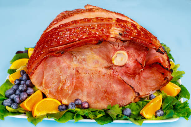 istock Spiral sliced hickory smoked ham with fresh orange and blueberries. 1308721366