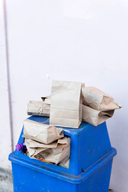 istock Blue color trashcan full of garbage 1308722933
