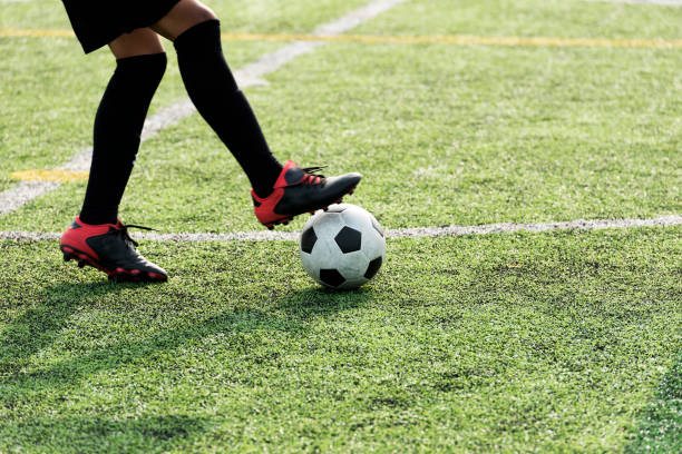 istock Player Training Ball in green soccer field 1308723795