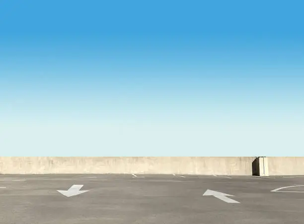 Empty parking lot in front of a blue sky