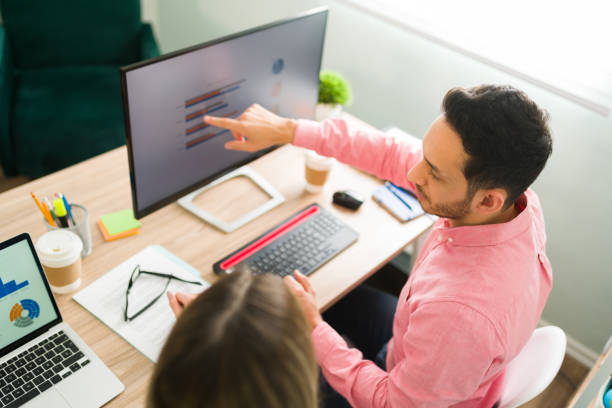istock Top view of business colleagues looking at a work presentation 1308732927