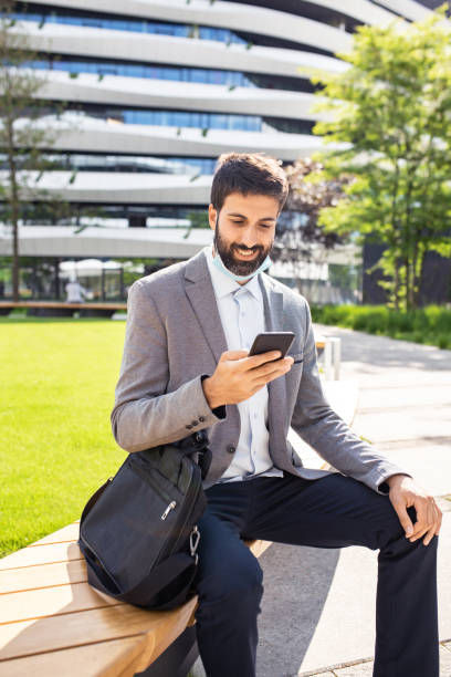 istock Businessman talking on a mobile phone in a business district 1308737600