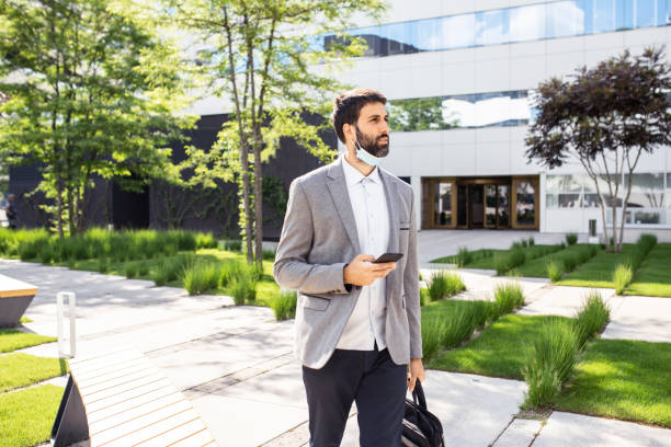 istock Businessman talking on a mobile phone in a business district 1308737651