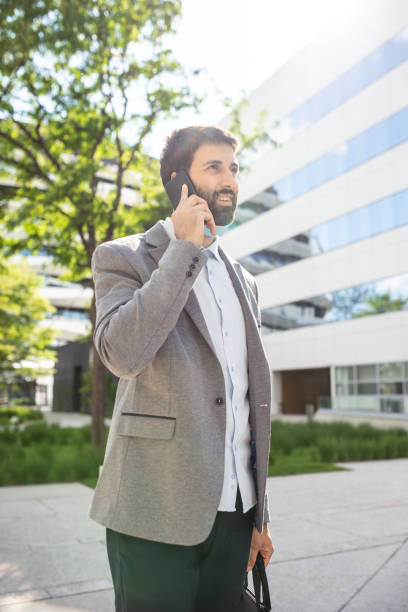 istock Businessman talking on a mobile phone in a business district 1308737835