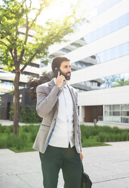 istock Businessman talking on a mobile phone in a business district 1308737864