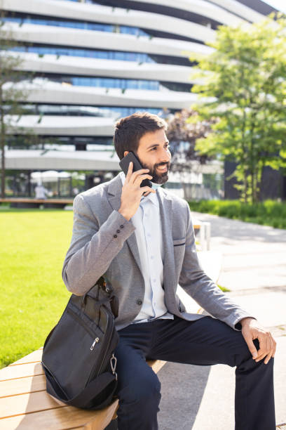 istock Businessman talking on a mobile phone in a business district 1308738489