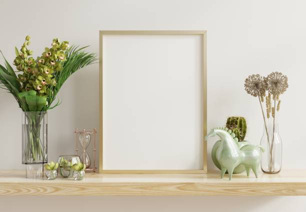 istock White mock up frame with vertical gold metal frame on the shelf. 1308740227
