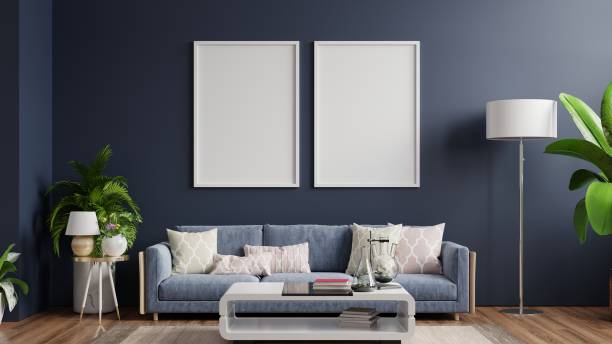 istock Interior poster mockup with vertical empty wooden frame standing on wooden floor with sofa on dark background. 1308740236