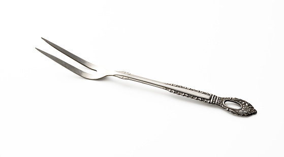 High angle view of steak and barbeque fork isolated on white with clipping path.