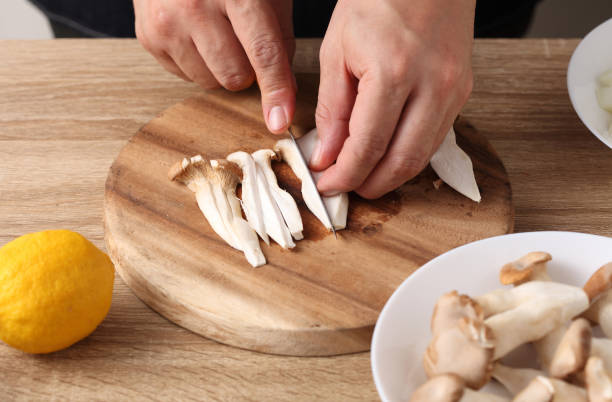 istock chef cut mushrooms on wooden tray in kitchen 1308751765