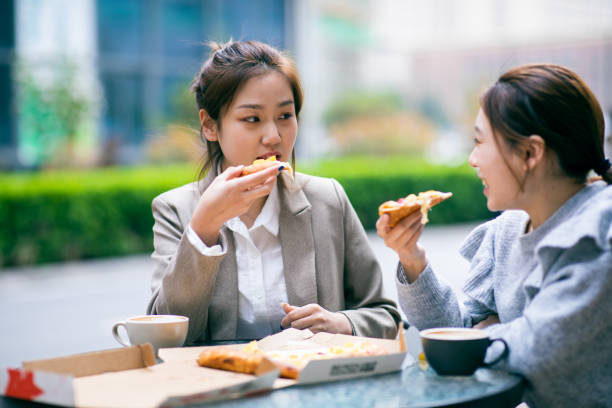 istock Young girls eating pizza 1308752909