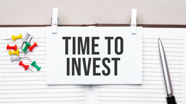istock text Time to invest on stickers on the diary with office tools 1308755139