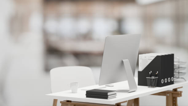 istock 3D rendering, office interior with simple office desk with computer and office supplies in blurred background 1308756805