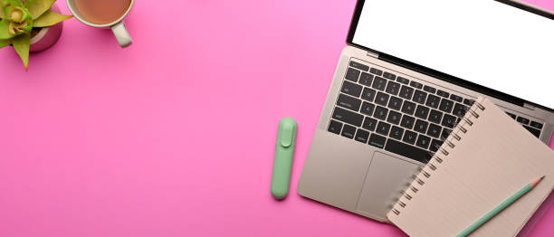 istock Pink creative flat lay workspace with laptop, stationery and copy space 1308756850