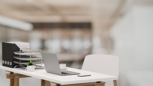 istock 3D rendering, office interior with simple office desk with laptop and office supplies in blurred background 1308756915