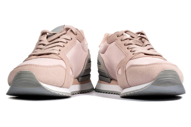 istock Light pink summer sneakers on a white background, front view 1308758008