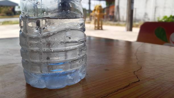 istock Water droplets beside the plastic bottle with cool temperature. 1308763858