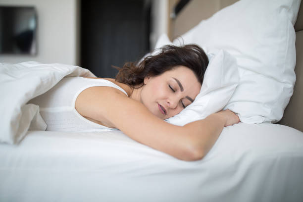 istock Beautiful young woman sleeping in bed 1308766487