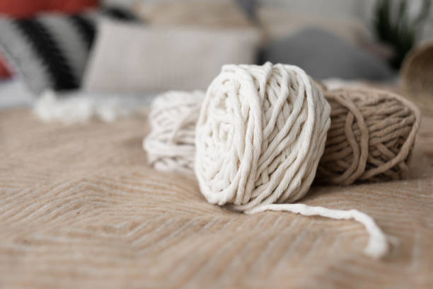 istock Roll of macrame rope. White and gray thread on a beautiful pastel background. 1308776368