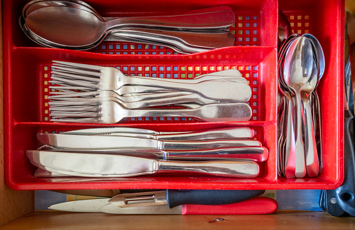 Cutlery in a kitchen drawer. Closeup view