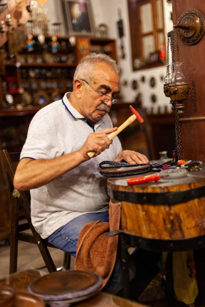 istock Experienced wood craftsman making handicrafts 1308782921