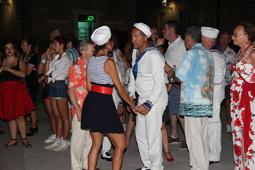Senigallia, Italy - August 8, 2019 is an international music festival focused on American music and culture of the 1950s here of wild dancers.\nIn the photo: people dressed up in the 50s style