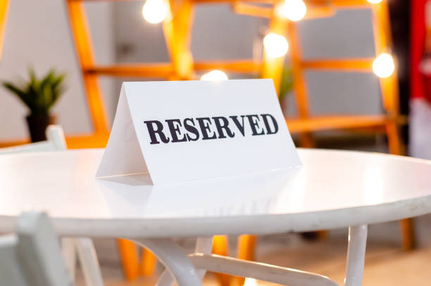 istock Reserved Sign On A Table In Restaurant 1308784919