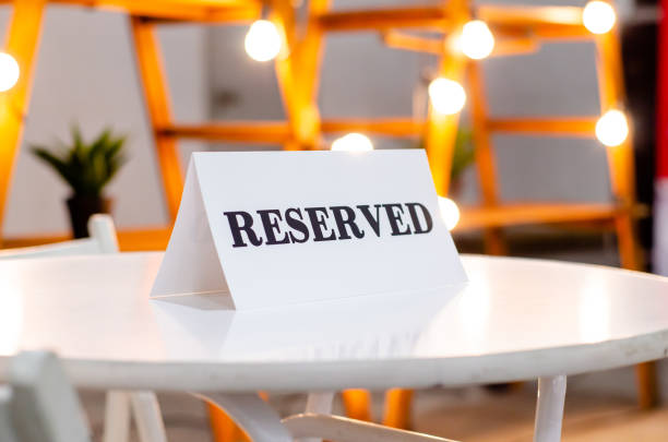istock Reserved Sign On A Table In Restaurant 1308785318