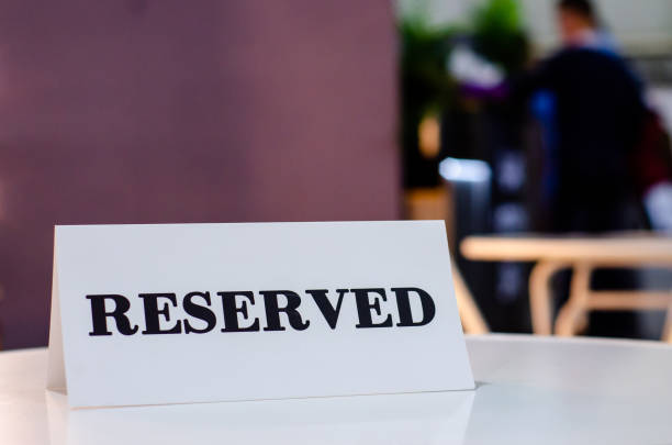 istock Reserved Sign On A Table In Restaurant 1308786323