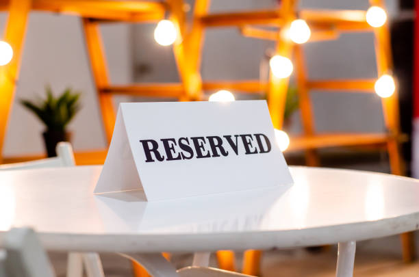 istock Reserved Sign On A Table In Restaurant 1308786403