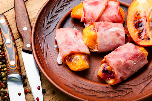 Tamarillo wrapped and baked with ham and bacon.Healthy food