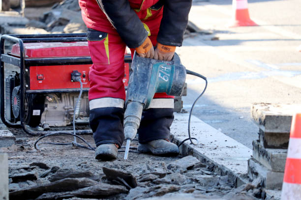 istock Worker repair the road surface with a jackhammer 1308793780