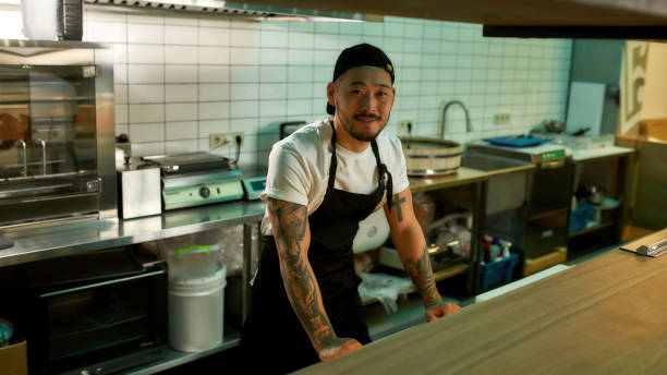 istock Man working in a large kitchen in a restaurant 1308795248