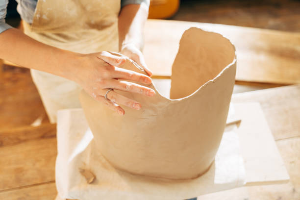 istock Woman making by hands big brown clay pot or vase 1308797909
