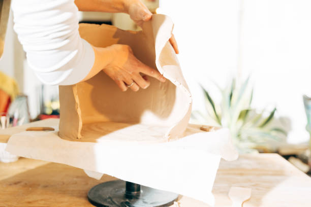 istock Closeup unknown woman preparing to work with wet clay in workshop 1308797926