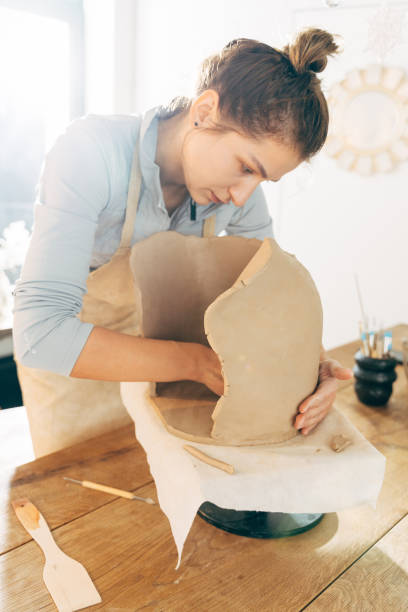 istock Vertical view of the woman potter working with clay ware 1308797929
