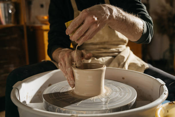 istock Craftsman artist shapes pot at the studio 1308798247